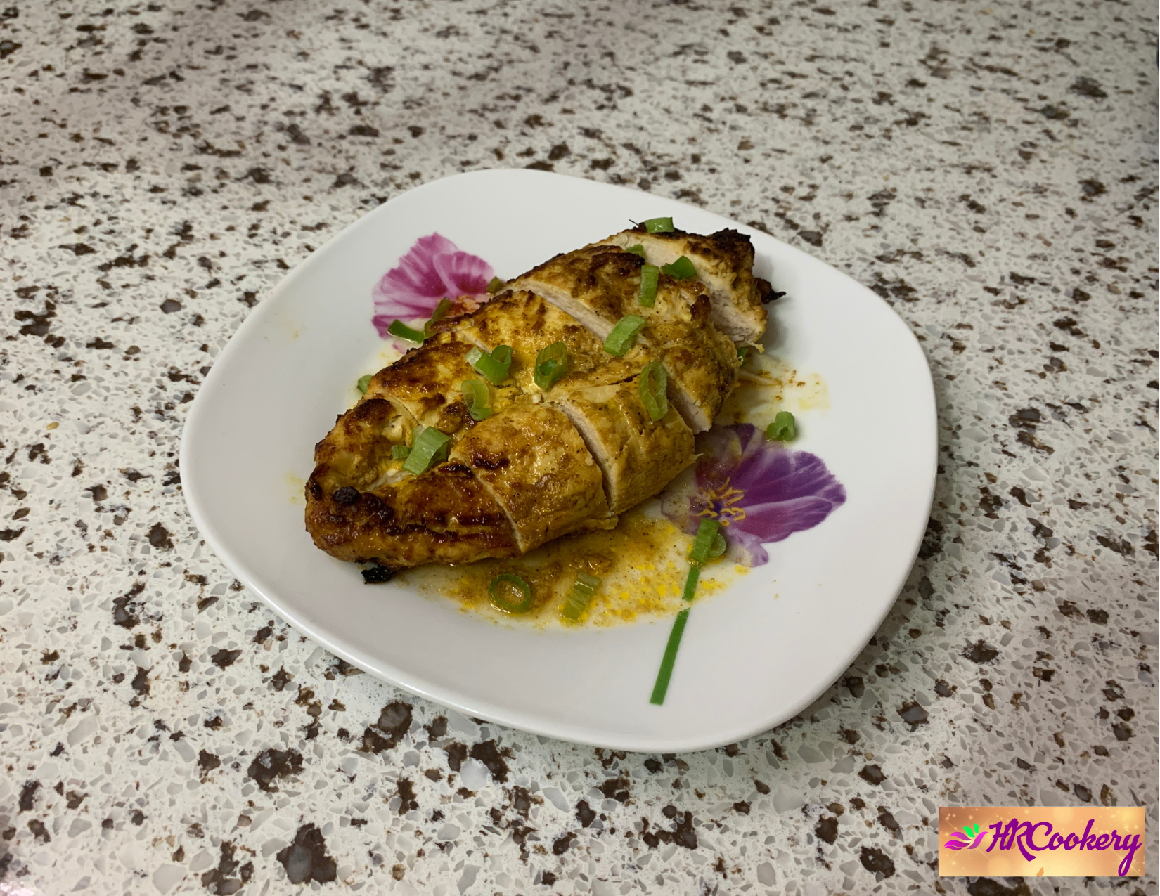 A bowl of chipotle chicken marinade made with chopped chipotle peppers, lime juice, garlic, and spices, beside fresh chicken breasts on a wooden cutting board.