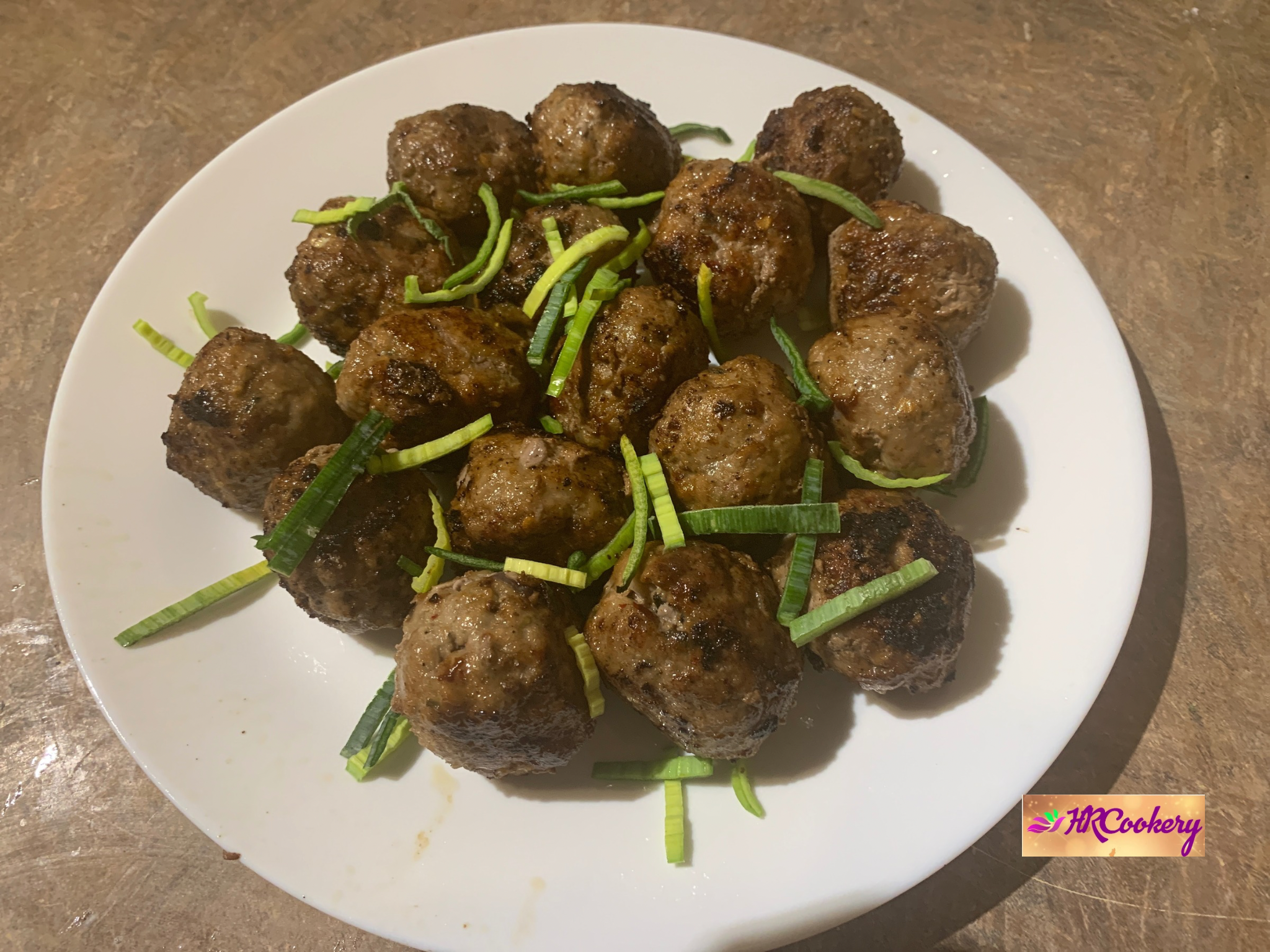 Greek keftedes (Greek meatballs) made with beef and lamb, seasoned with oregano and garlic, served with tzatziki and fresh herbs.