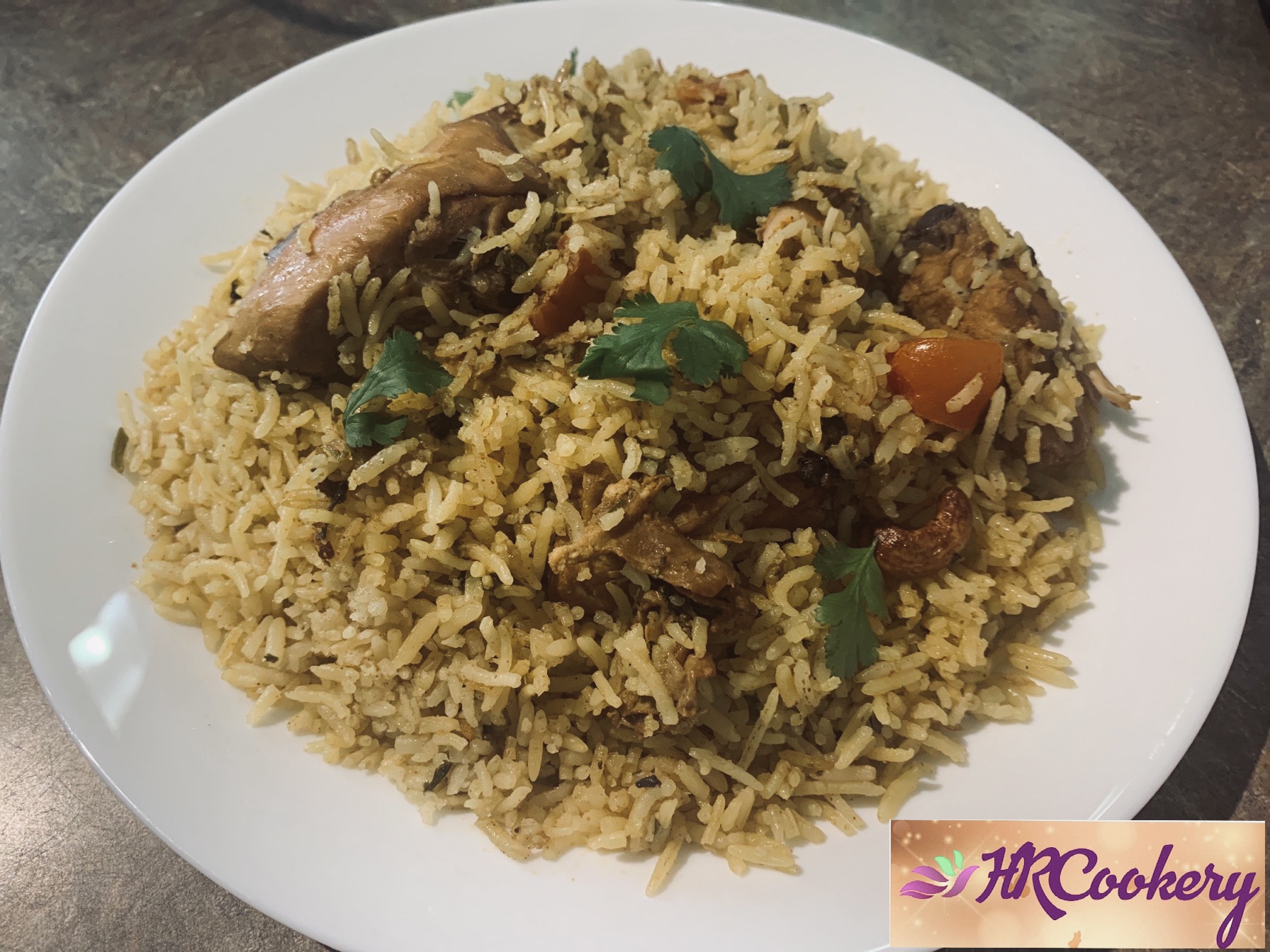 A vibrant bowl of chicken biryani featuring fragrant basmati rice, marinated chicken pieces, and garnished with fried onions, cilantro, and hard-boiled eggs.