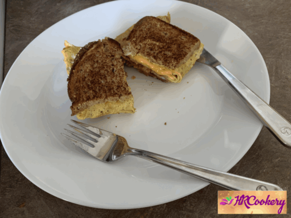 Golden-brown one-pan egg toast on a white plate.