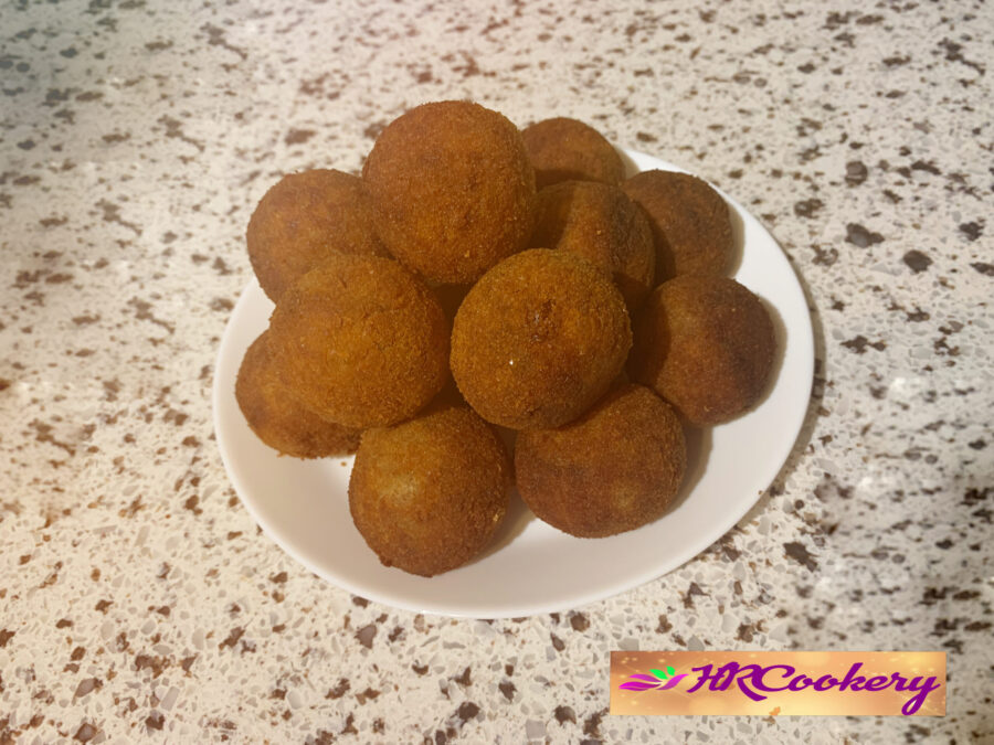 Golden-brown fried cutlets resting on a paper towel-lined plate, sizzling with a crispy texture.