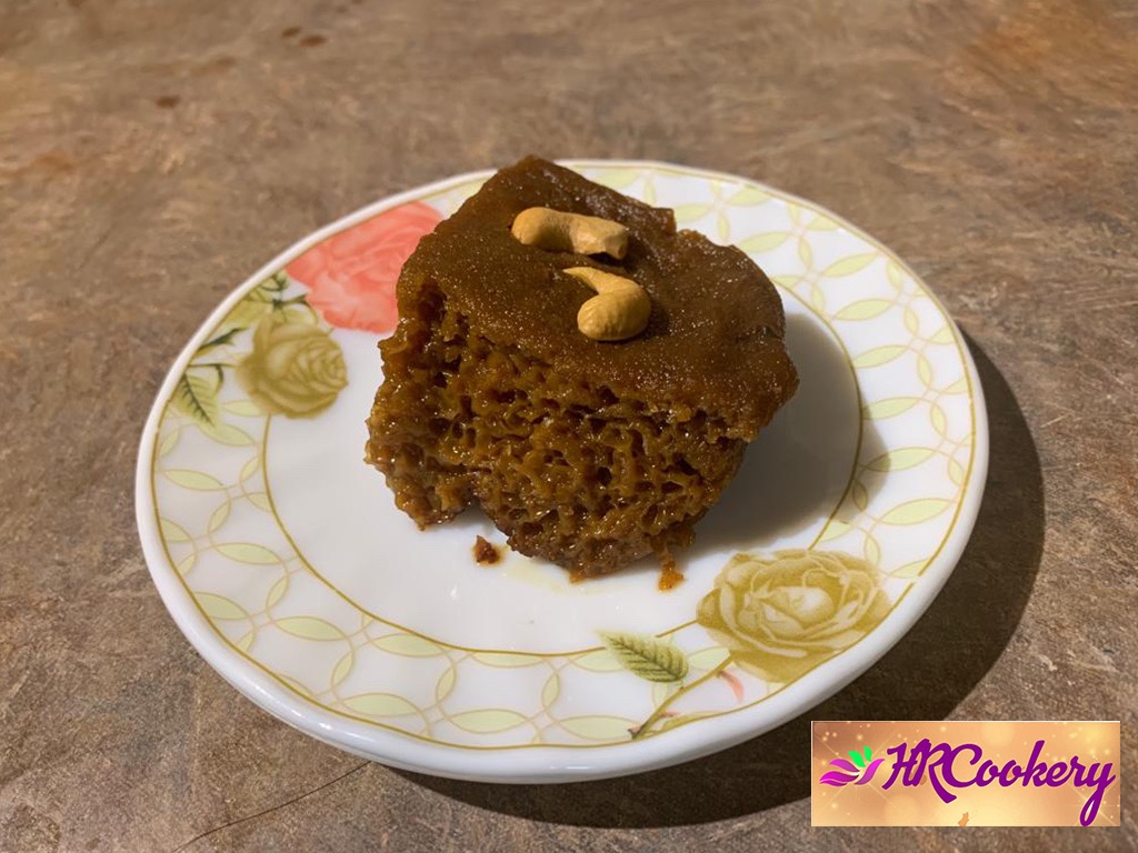 A beautifully plated portion of watalappam, a traditional Sri Lankan dessert made with coconut milk, jaggery, and spices, garnished with a sprinkle of grated coconut.