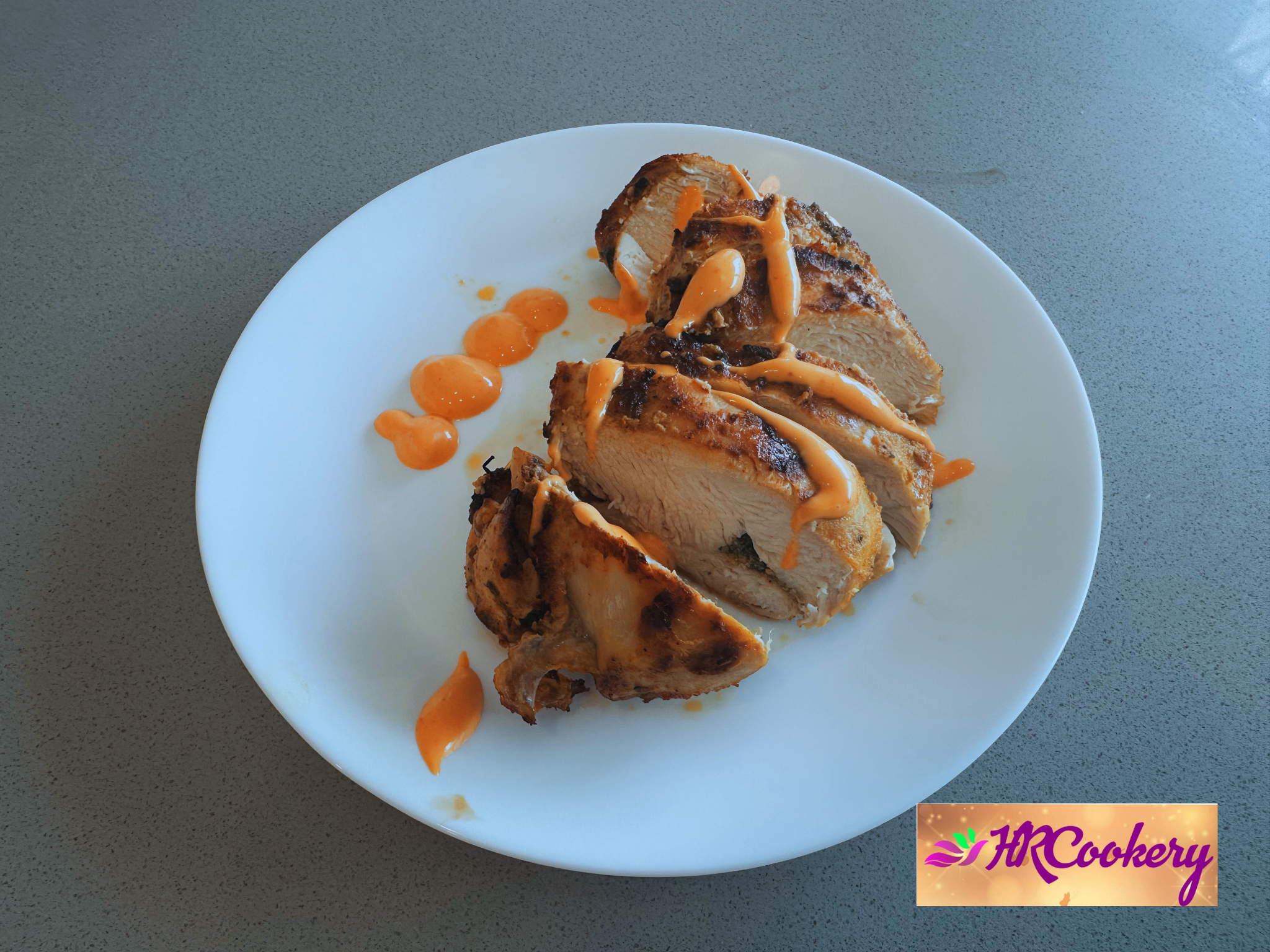 Grilled fajita chicken served on a white plate with colorful sauce.