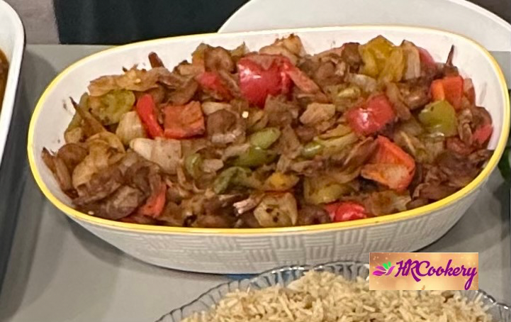 Sri Lankan spicy deviled prawns with onions, peppers, and green chilies in a glossy red sauce