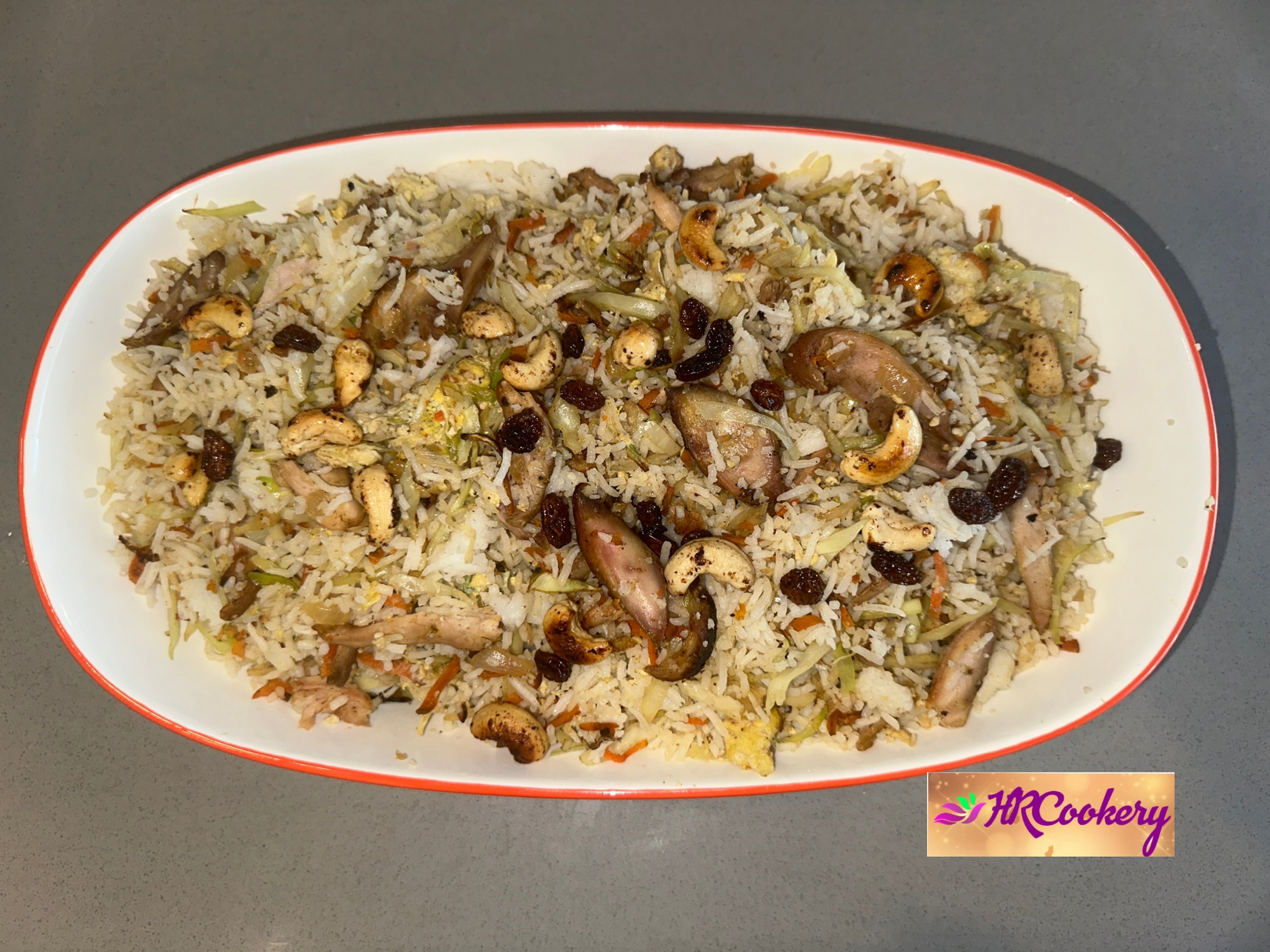 Sri Lankan chicken fried rice served with cashews, raisins, and chili paste.