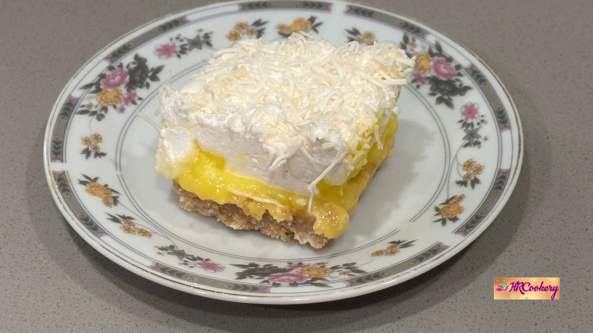 Custard and coconut marshmallow bar layered with creamy custard and coconut topping on a plate