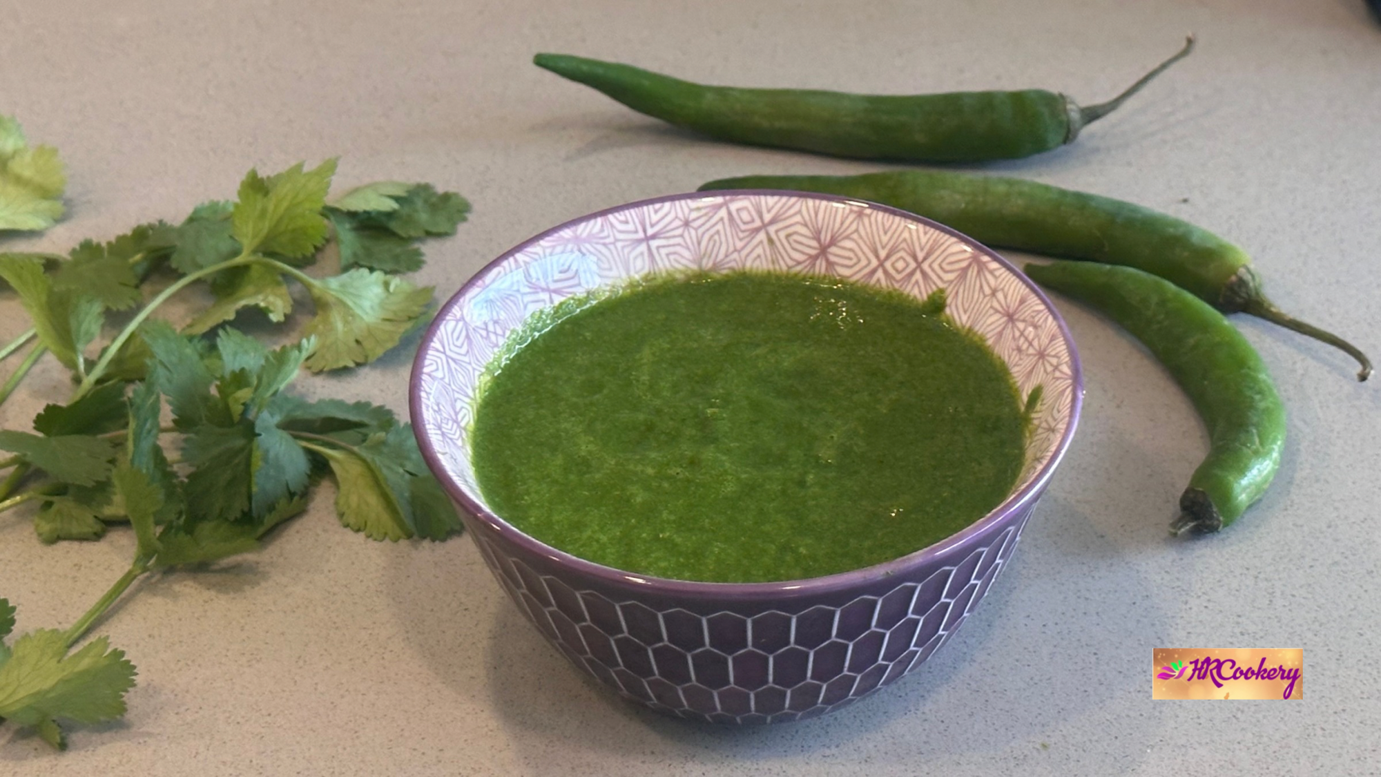 Fresh green chutney served in a bowl with cilantro and green chilies